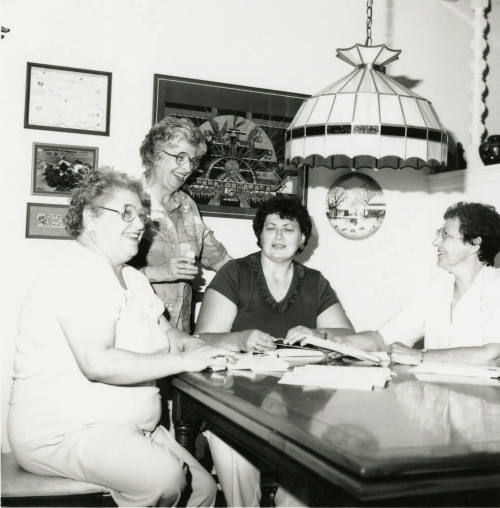 Four unidentified women at a table