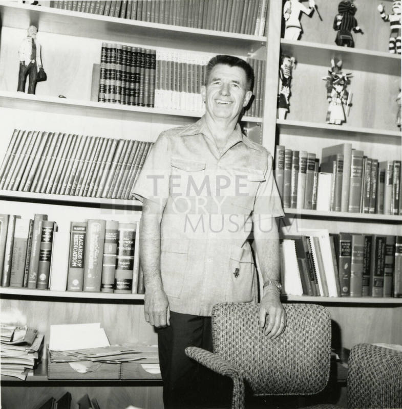 Unidentified man standing in front of medical books