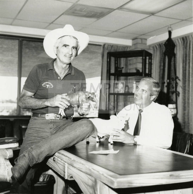 Tex Earnhardt and an unidentifed man at a desk