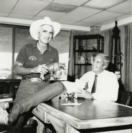 Tex Earnhardt and an unidentifed man at a desk