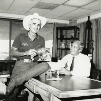Tex Earnhardt and an unidentifed man at a desk