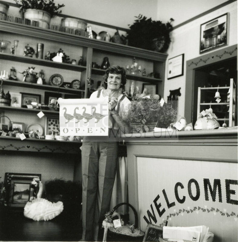 Unidentified lady standing at the counter of a craft shop