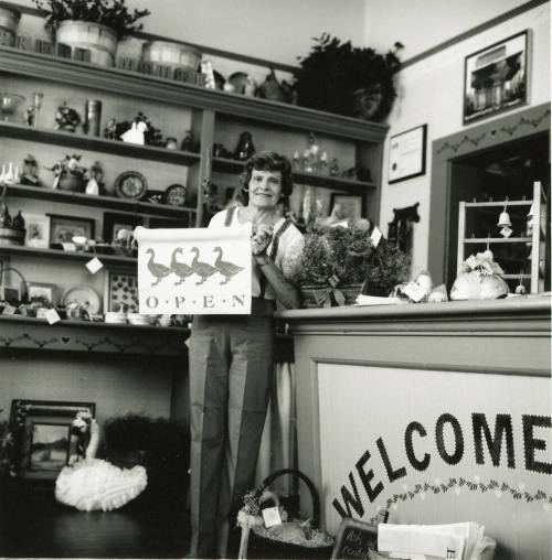 Unidentified lady standing at the counter of a craft shop