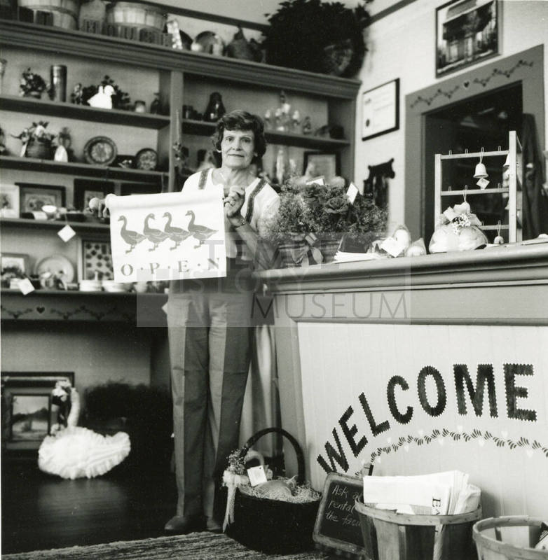 Unidentified lady standing at the counter of a craft shop