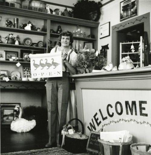 Unidentified lady standing at the counter of a craft shop