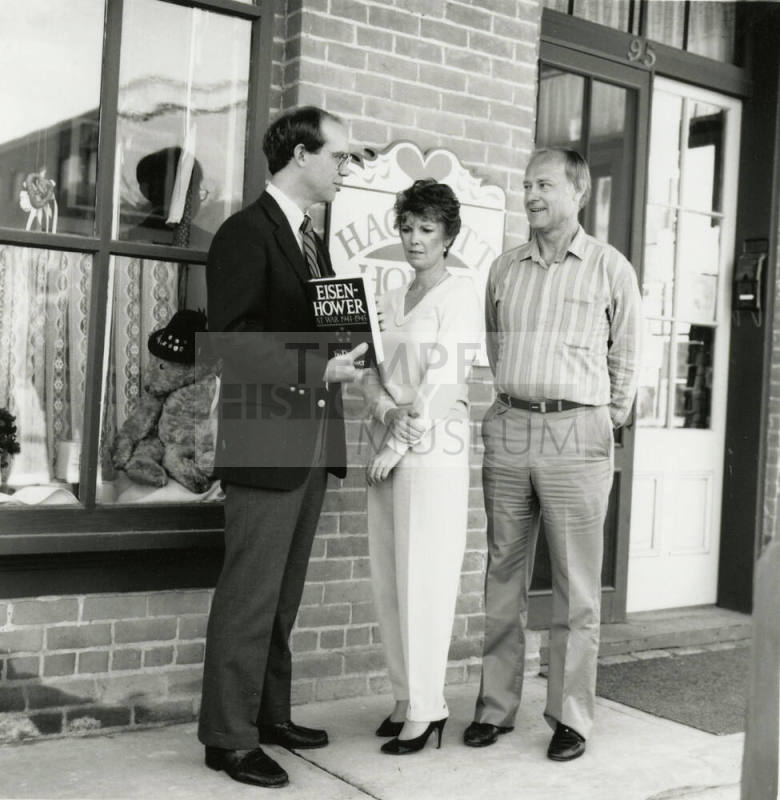 David Eisenhower and a couple stand in front of Hackett House, Sister City Oktoberfest