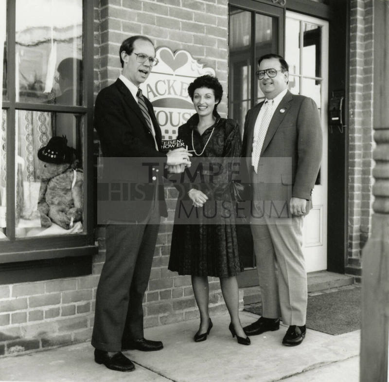 David Eisenhower and a couple stand in front of Hackett House, Sister City Oktoberfest