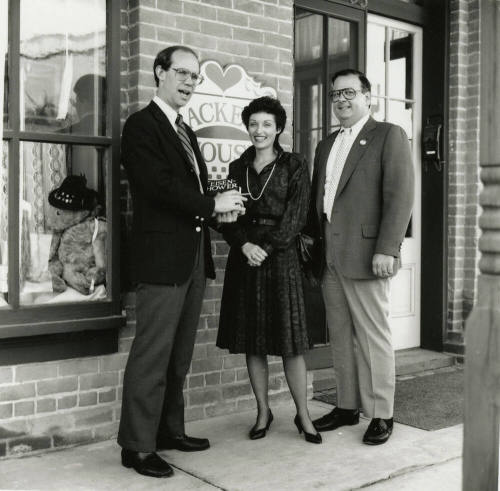 David Eisenhower and a couple stand in front of Hackett House, Sister City Oktoberfest