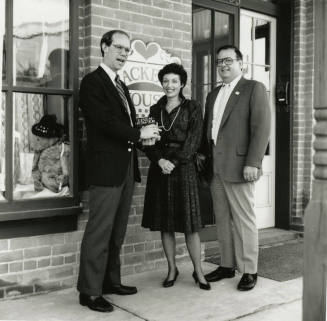 David Eisenhower and a couple stand in front of Hackett House, Sister City Oktoberfest