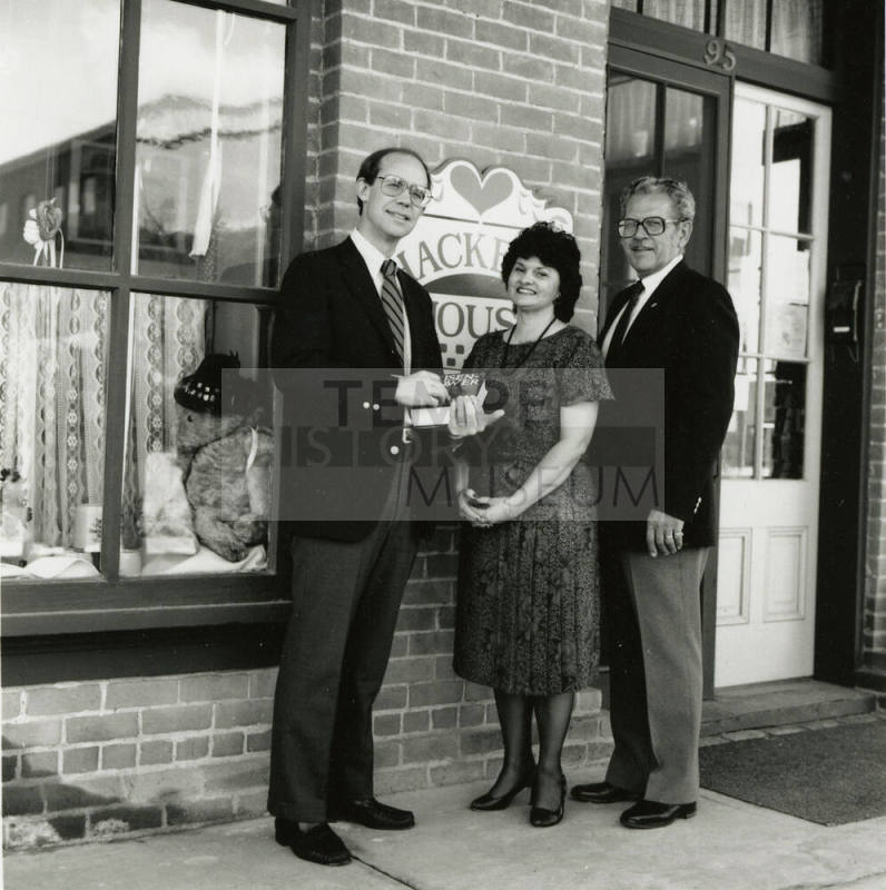 David Eisenhower and a couple stand in front of Hackett House, Sister City Oktoberfest