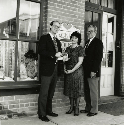 David Eisenhower and a couple stand in front of Hackett House, Sister City Oktoberfest
