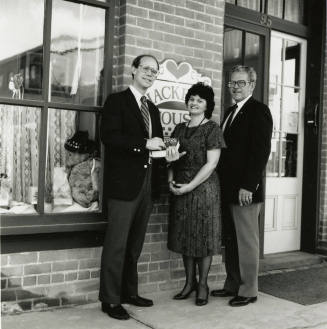 David Eisenhower and a couple stand in front of Hackett House, Sister City Oktoberfest
