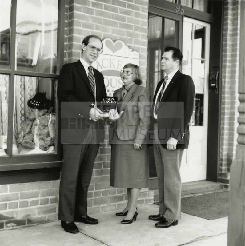 David Eisenhower and a couple, standing in front of Hackett House, Sister City Oktoberfest