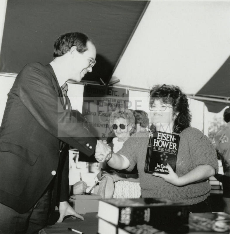 David Eisenhower and a woman at a book signing, Sister City Oktoberfest