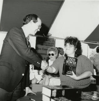 David Eisenhower and a woman at a book signing, Sister City Oktoberfest