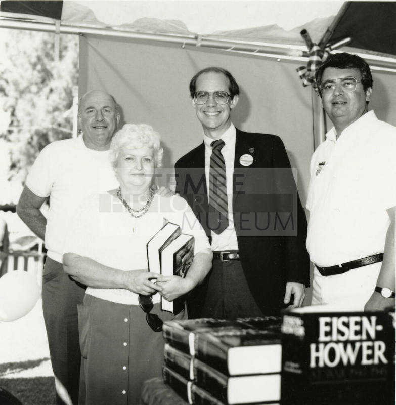 David Eisenhower and two men and a woman at a book signing, Sister City Oktoberfest