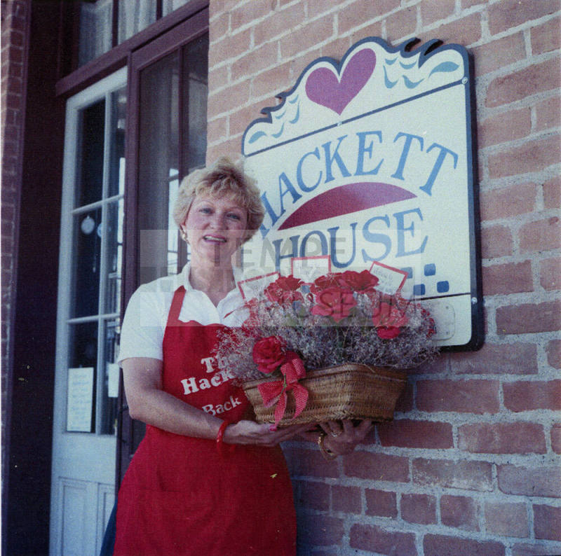 Jane Neuheisel holds flowers at the Hackett House