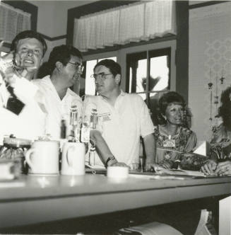 People at the counter inside the Hackett House