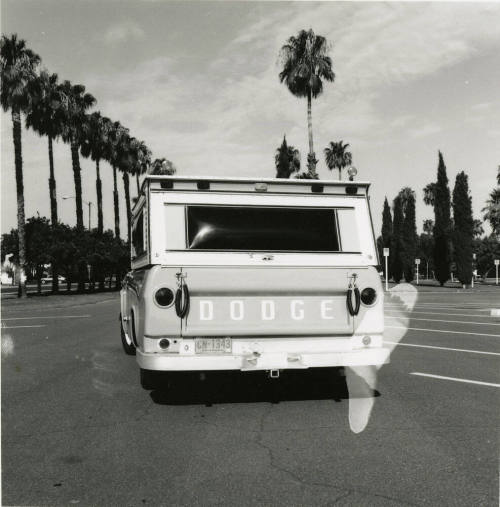 Dodge truck parked in an empty parking lot, photographed from the back
