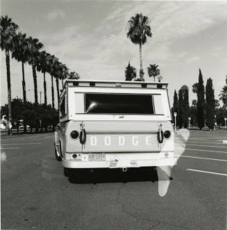 Dodge truck parked in an empty parking lot, photographed from the back