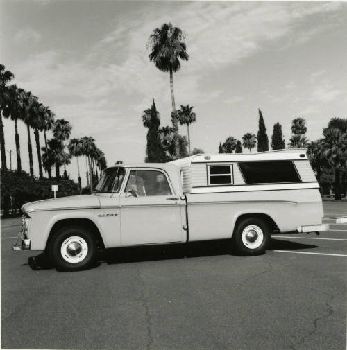 Dodge truck parked in an empty parking lot, photographed from the side