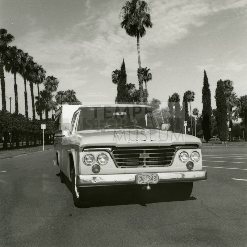 Dodge truck parked in an empt parking lot, photographed from the front.