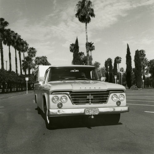 Dodge truck parked in an empt parking lot, photographed from the front.