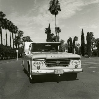 Dodge truck parked in an empt parking lot, photographed from the front.