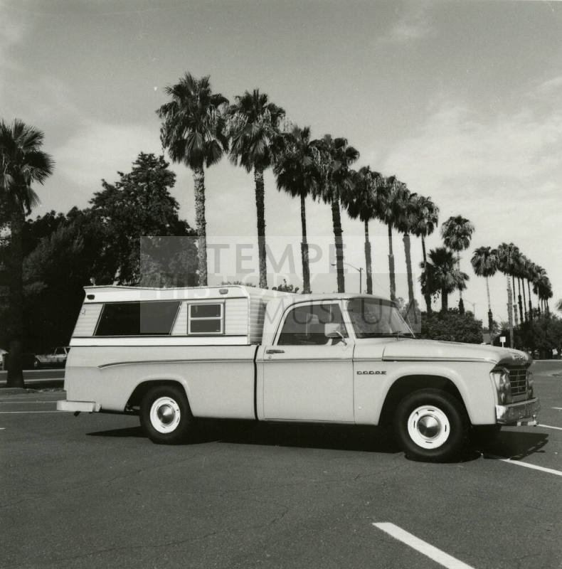 Dodge truck parked in an empty parking lot, photographed from the side