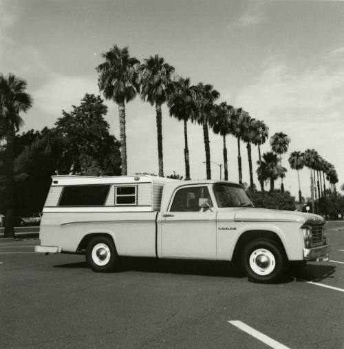 Dodge truck parked in an empty parking lot, photographed from the side