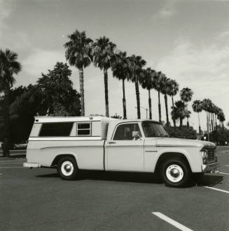 Dodge truck parked in an empty parking lot, photographed from the side