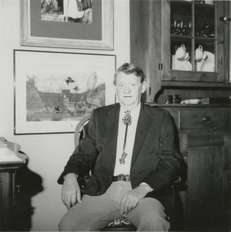 Unidentified seated man wearing bolo tie