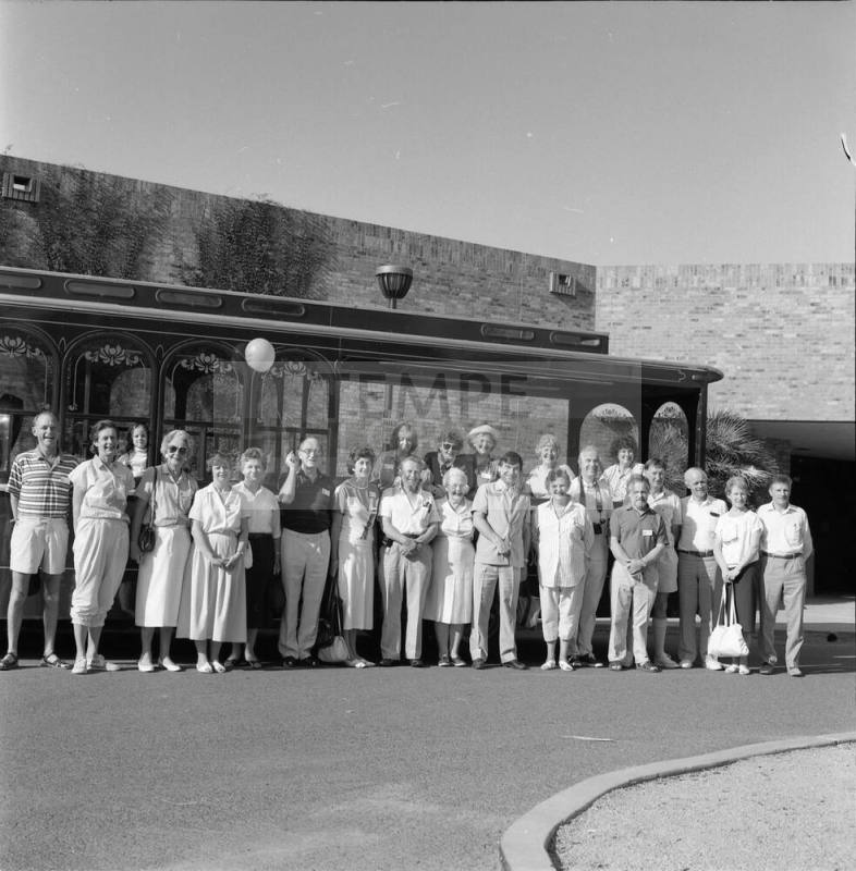 Large unidentified group outside a brick building