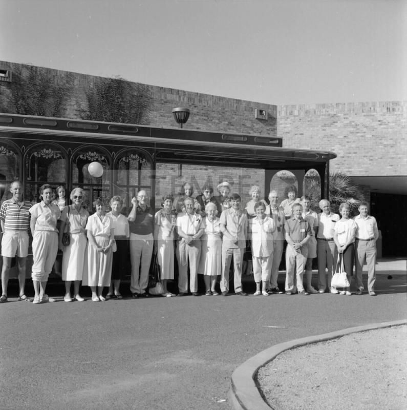 Large unidentified group outside of a brick building