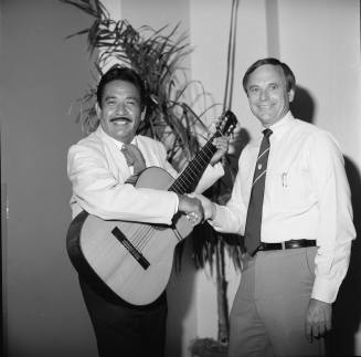 Harry Mitchell Shakes Hands with Unidentified Musician