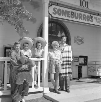 The Vasquez family standing outside of Someburro's on Mill and Baseline