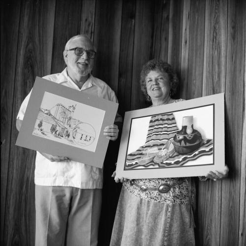 Richard Nearing showing his "Hayden Flour Mill' pen and ink, Jeanne Sweet with her pastel "The Green Moccasins"