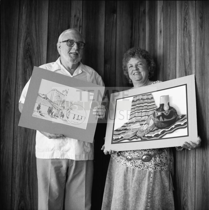 Richard Nearing showing his "Hayden Flour Mill' pen and ink, Jeanne Sweet with her pastel "The Green Moccasins"