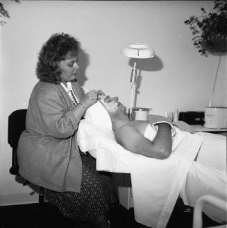Opening of "Salon Enchanté" Blake Harris is recieving a 'European Facial' from Peggy Thomas, Salon director and owner