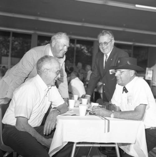 Tempe High Annual Reunion, for gentlemen gathered around a table talking