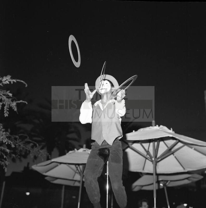 Clown juggling Rings on a Unicycle