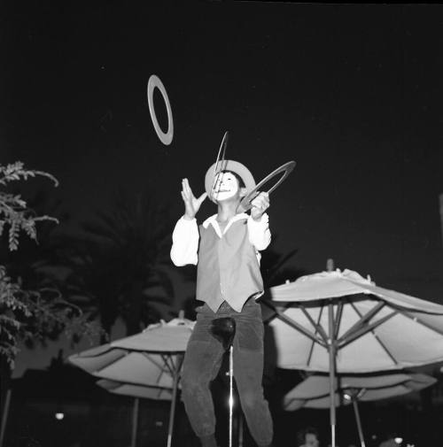 Clown juggling Rings on a Unicycle