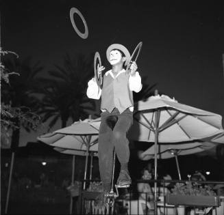 Clown juggling Rings on a Unicycle