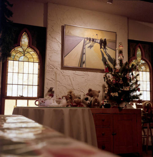 Small Christmas tree with stuffed animals on a table