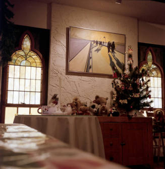 Small Christmas tree with stuffed animals on a table