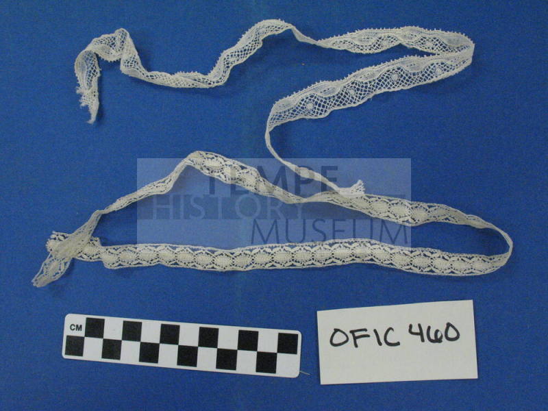Two thin strips of lace cream colored
