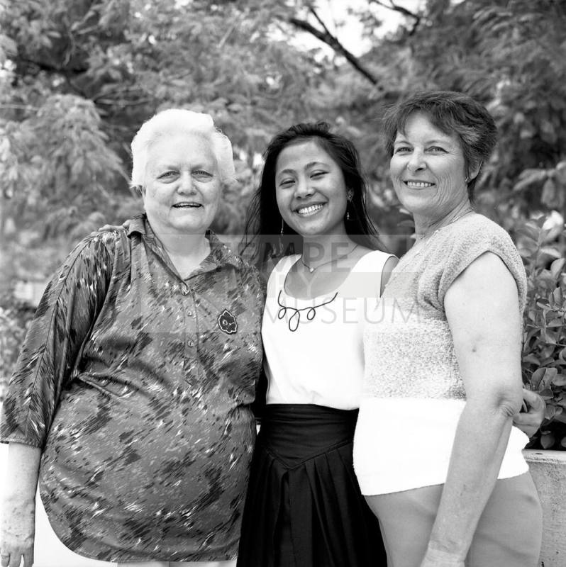 Portrait photo of a smiling girl w/ family
