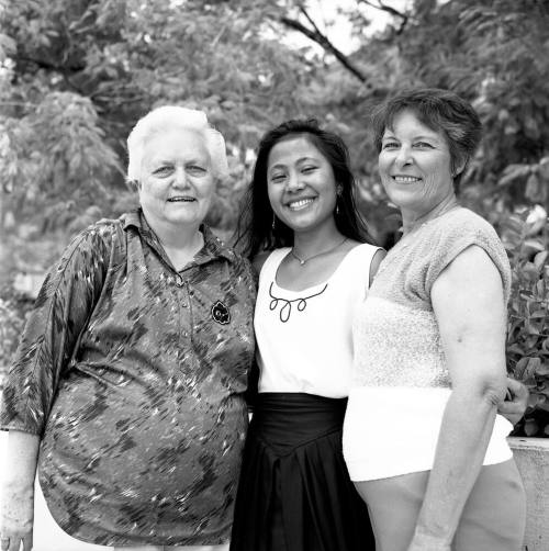 Portrait photo of a smiling girl w/ family