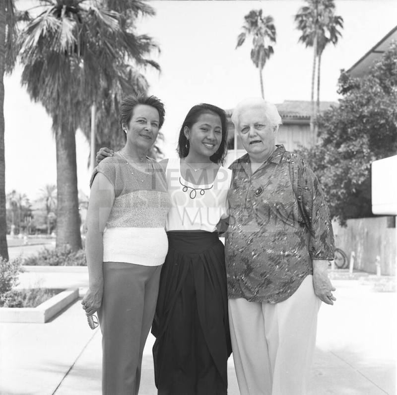 Portrait photo of a smiling girl w/ family