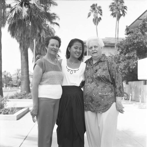 Portrait photo of a smiling girl w/ family